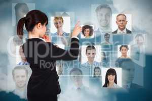 Composite image of thoughtful businesswoman pointing