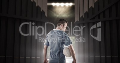 Composite image of rugby player holding a rugby ball 3d