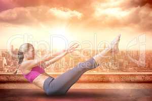 Composite image of focused fit blonde doing yoga on the beach