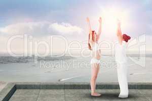 Composite image of relaxed women doing yoga
