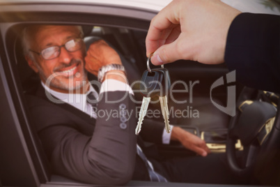 Composite image of woman smiling while receiving car keys