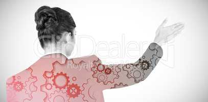 Composite image of rear view of businesswoman using digital screen