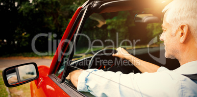 Mature man driving cabriolet