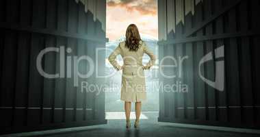 Composite image of businesswoman standing back to camera 3d