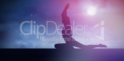 Composite image of sporty woman with joined hands over head at a fitness studio