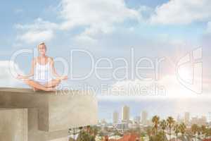 Composite image of  fit woman doing yoga