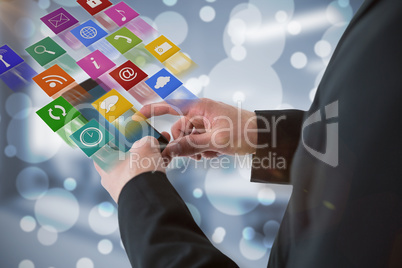 Composite image of businessman using smart phone 3d