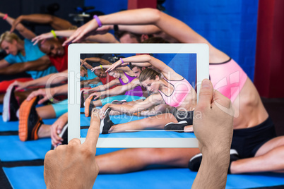 Composite image of hand holding tablet pc