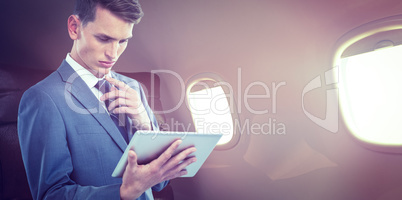 Composite image of thoughtful businessman looking at tablet pc