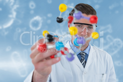 Composite image of portrait of scientist holding molecule structure 3d