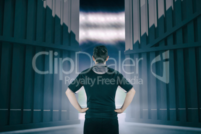 Composite image of back turned rugby player with hands on hips 3d