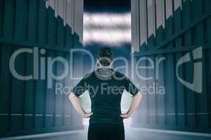 Composite image of back turned rugby player with hands on hips 3d