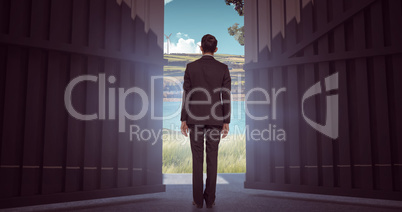Composite image of businessman turning his back to camera 3d