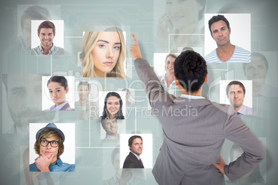 Composite image of asian businesswoman pointing