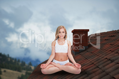 Composite image of portrait of young woman sitting in lotus position with eyes clos