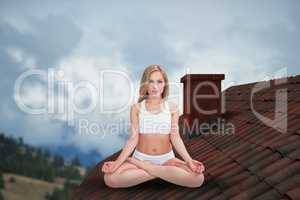 Composite image of portrait of young woman sitting in lotus position with eyes clos