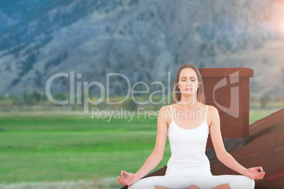 Composite image of toned woman in lotus pose at fitness studio