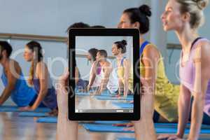 Composite image of close-up of hands holding digital tablet