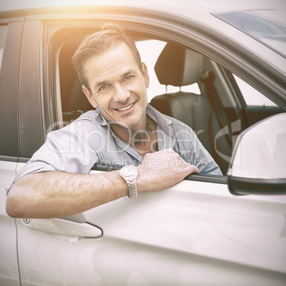 man smiling at camera in a car