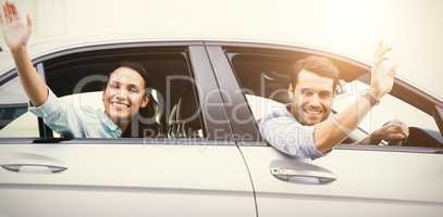 Young couple smiling and waving