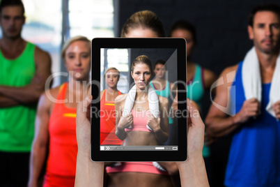 Composite image of close-up of hands holding digital tablet