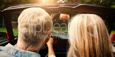 Rear view of mature couple going for ride together