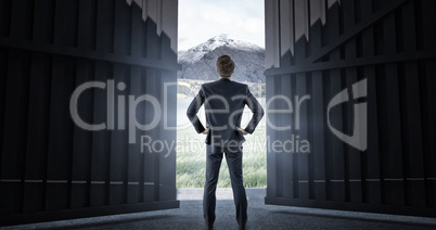 Composite image of wear view of businessman with hands on hip 3d
