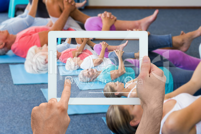 Composite image of hand holding tablet pc