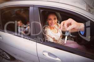 Composite image of customer receiving car keys