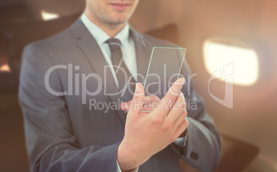 Composite image of businessman using futuristic mobile phone