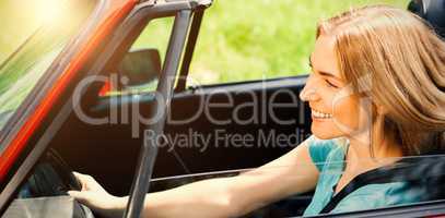 Beautiful woman driving red cabriolet