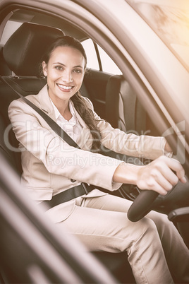 Pretty businesswoman smiling and driving