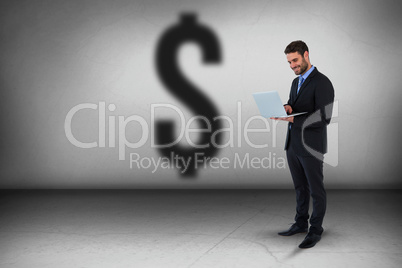 Composite image of businessman standing while using laptop computer