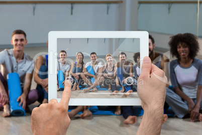 Composite image of hand holding tablet pc