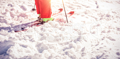 Low section of skier on snowy field