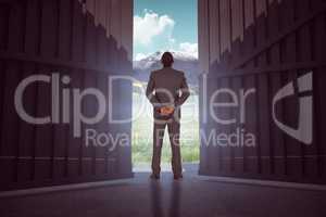 Composite image of young businessman standing with hands behind back 3d