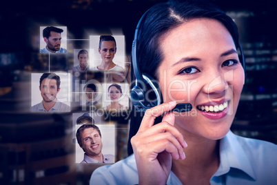 Composite image of smiling businesswoman using headset