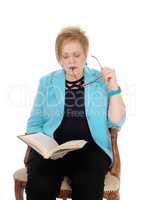 Senior woman reading book.