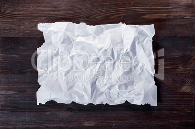 Crumpled white blank sheet with burnt edges