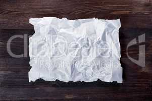 Crumpled white blank sheet with burnt edges