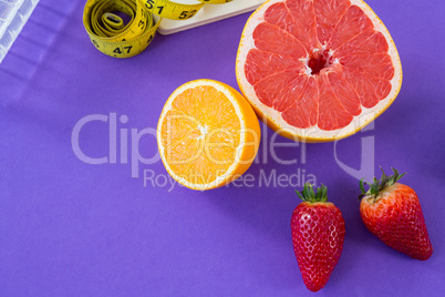 Grapefruit, lemon, strawberry with measuring tape