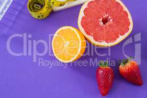 Grapefruit, lemon, strawberry with measuring tape