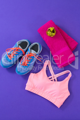 Sneakers, sports bra, towel and measuring tape