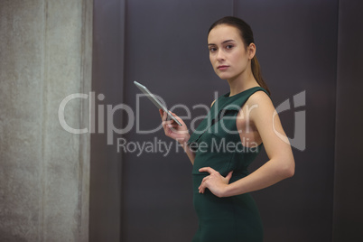 Businesswoman holding digital tablet at office