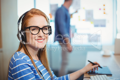 Female graphic designer working with headphones