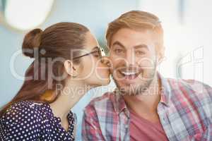 Affectionate woman kissing man