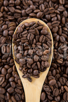 Roasted coffee beans with wooden spoon