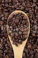 Roasted coffee beans with wooden spoon