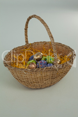 Various Easter eggs in wicker basket