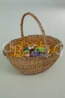 Various Easter eggs in wicker basket